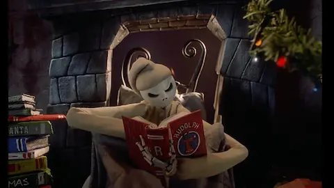 Jack Skellington lendo um livro escrito Rudolph na capa